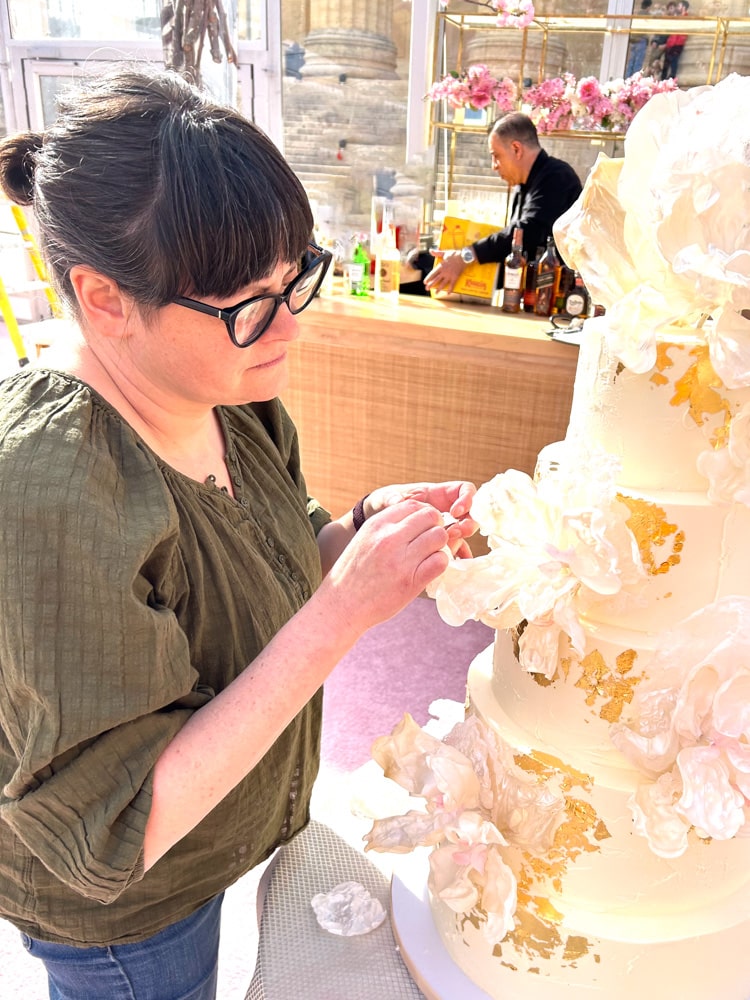 Zoë adding the finishing touches to a wedding cake at the Philadelphia Museum of Art